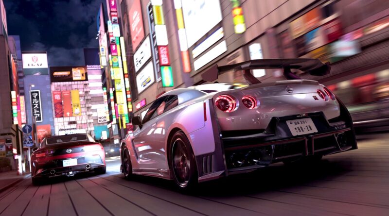 Silver Nissan GT-R with large rear wing speeds through a neon-lit city street at night, behind a black car; motion blur adds speed feel.