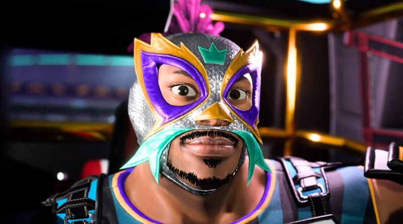 Close-up of a person wearing a bright luchador mask with purple, gold, and teal accents, looking at the camera in a colorful costume.