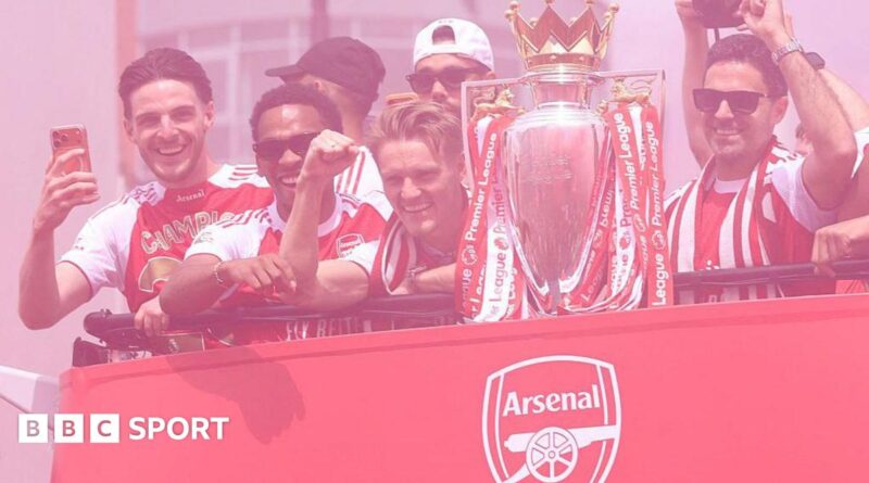 Arsenal players celebrate on an open-top bus with the Premier League trophy, BBC Sport logo in the corner