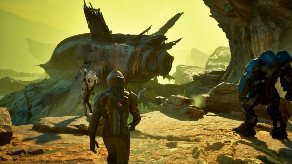 Astronauts explore a rocky canyon past a large crashed spaceship with thruster wings and yellowish light in the background