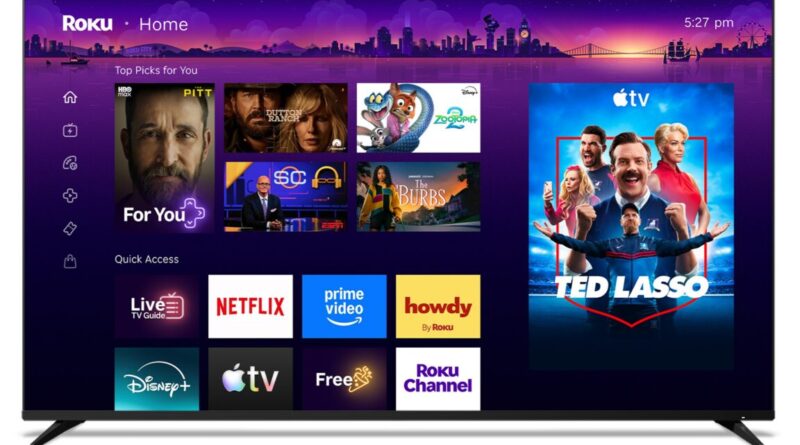 Roku Home screen showing a purple city skyline background, Top Picks grid, and a large Ted Lasso poster on the right.