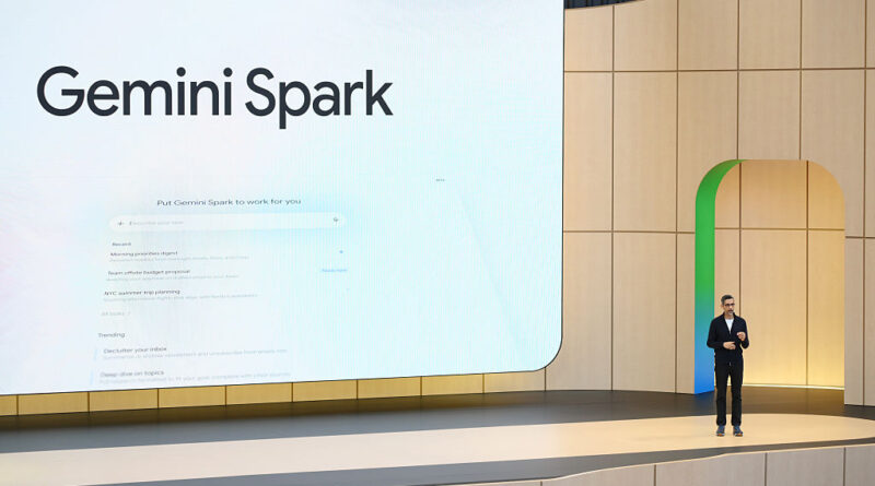 Speaker on stage presents Gemini Spark logo on a large screen in a modern auditorium setting