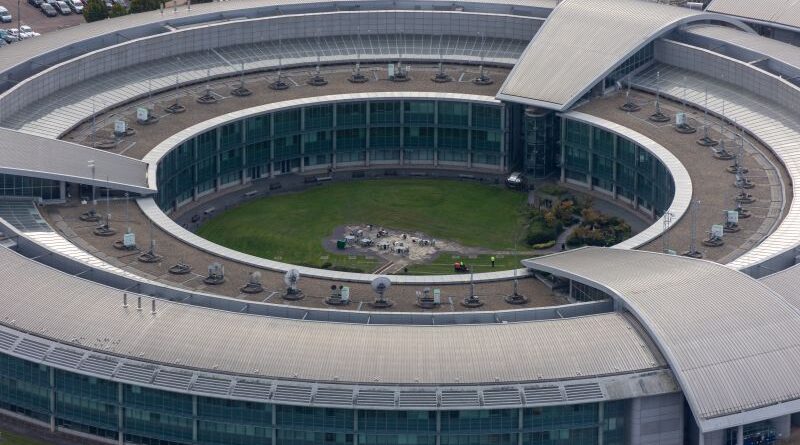 Aerial view of a large circular office building with a central grassy courtyard inside the ringed structure.