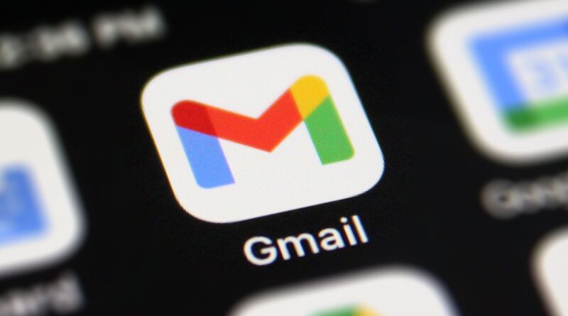 Gmail app icon on a smartphone home screen (close-up) with a white rounded square and colorful red, blue, yellow, and green 'M' symbol under the label Gmail.