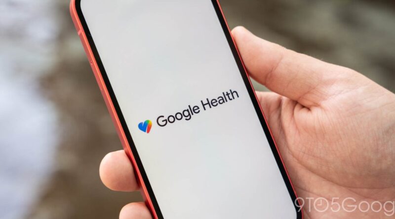 Close-up of a hand holding a red smartphone displaying the Google Health logo on a white screen.