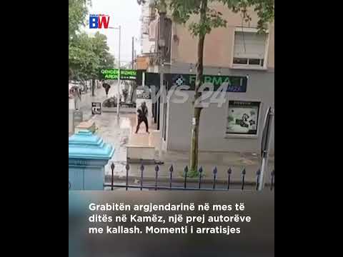 CCTV frame of a daytime street robbery in Kamëz: a man fleeing from a jewelry store, one of the perpetrators carrying a Kalash rifle.