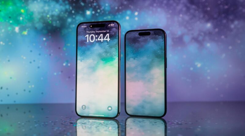 Two smartphones with edge-to-edge displays stand upright on a reflective surface against a colorful, starry background.