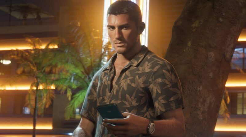 Man wearing a patterned short-sleeve shirt leans against a tree at night, holding a smartphone.