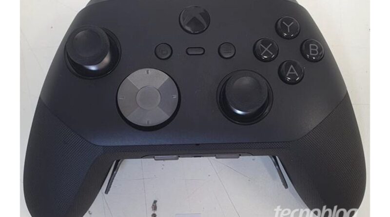 Front view of a black wireless game controller with two analog sticks, a D-pad, and A/B/X/Y action buttons on the right and thumb grips on the sides.