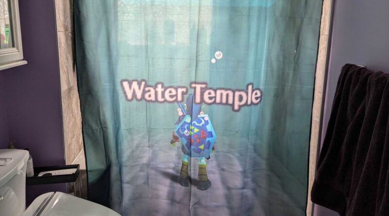 Shower curtain in a purple bathroom featuring a cartoon underwater character and the text 'Water Temple'.