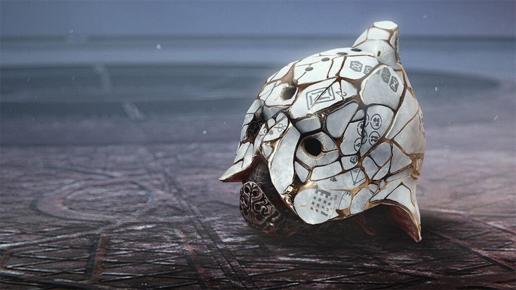 A mosaic shell sculpture made of broken ceramic tiles sits on a dark, textured surface with a misty seascape in the background.
