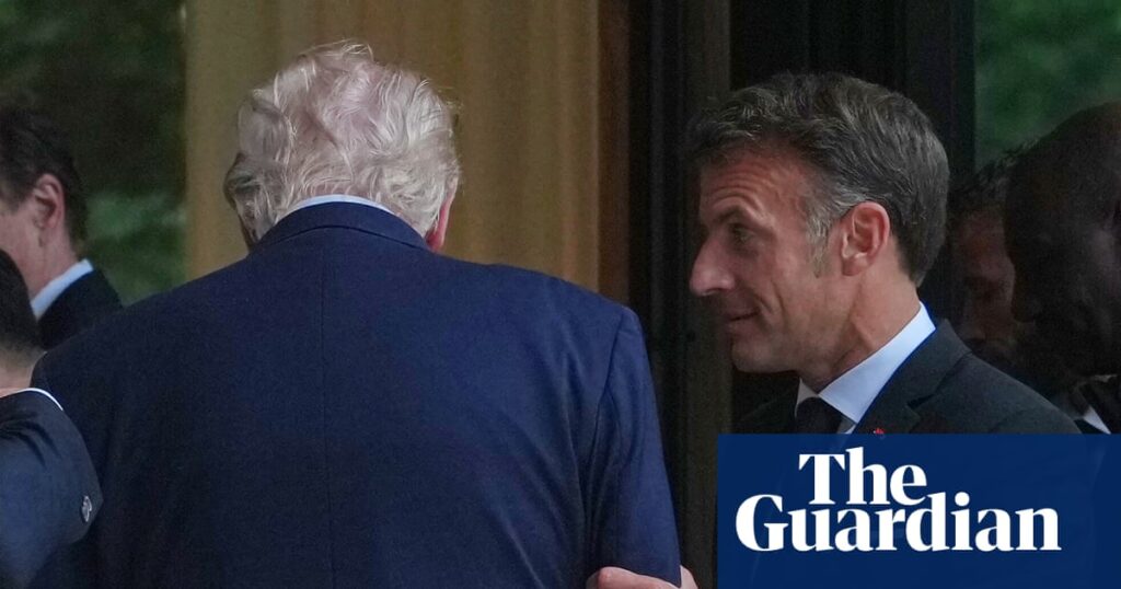 Two men in suits greet each other at a doorway, Guardian logo watermark in the corner, likely at a formal event.