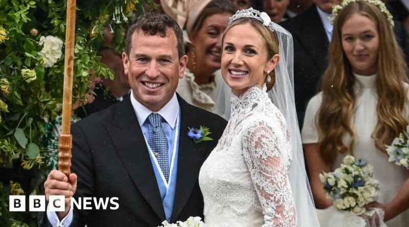 Bride and groom smile for the camera at a wedding, with bridesmaids in the background and the BBC News logo visible.
