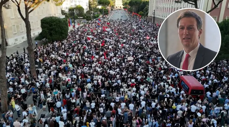 Aerial view of a massive street protest with thousands of people, many holding signs; a circular inset shows a man in a suit and red tie.