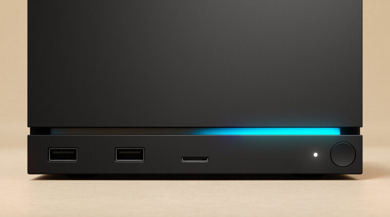 Front view of a black computer tower with two USB-A ports, a slim media/SD card slot, a blue LED glow, and a circular power button with a small indicator light.