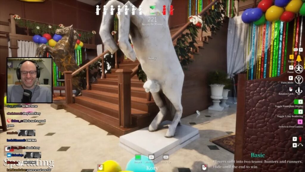 Live stream screenshot: player with headset in webcam box watches a 3D horse statue amid colorful party decor and a stair backdrop; UI overlays visible.