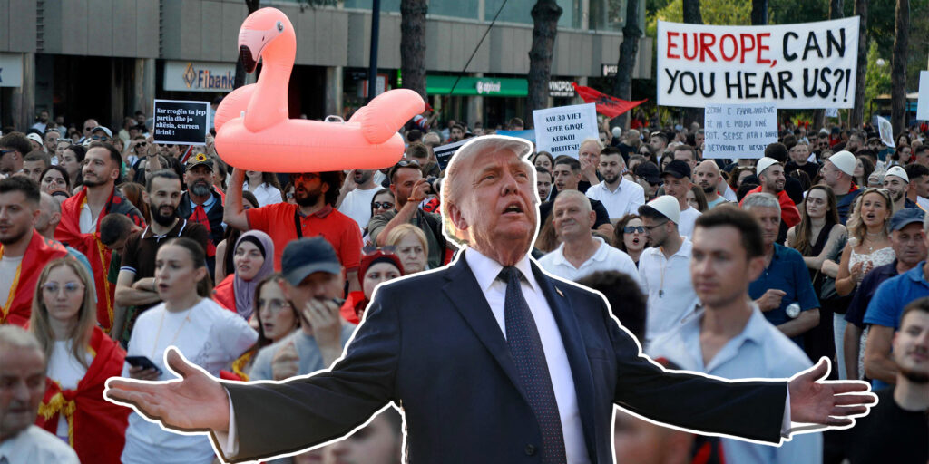 Crowd of protesters with a life-size Trump cutout in a suit, arms wide, large pink flamingo inflatable nearby, and banners in the background.
