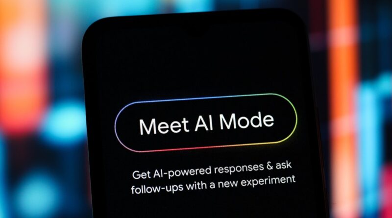 Phone screen showing a rounded 'Meet AI Mode' button with the line 'Get AI-powered responses & ask follow-ups with a new experiment'.