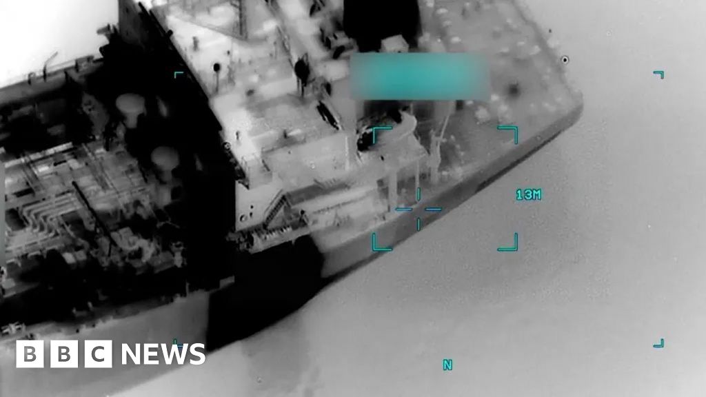 Drone/overhead view of a vessel at sea with digital targeting HUD overlays; BBC News watermark visible.
