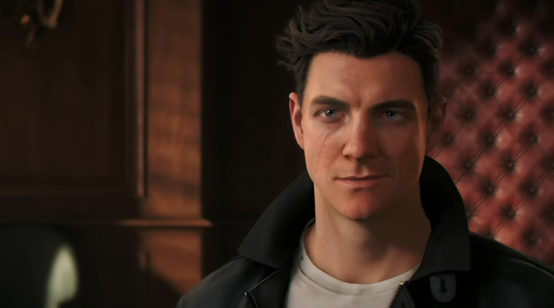 Man with dark hair in a black leather jacket gazes ahead in a warm, wood-paneled room with tufted red leather wall behind him.