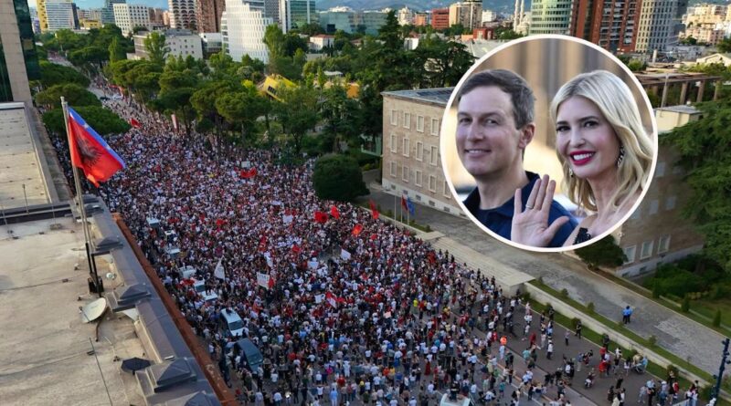 Aerial view of a city street filled with a dense protest crowd holding red flags; circular inset shows a smiling couple waving at the camera.