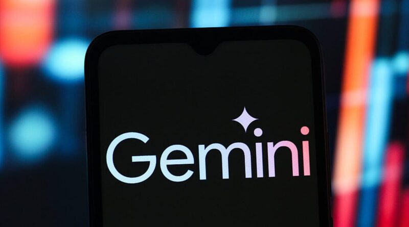 Smartphone screen showing the Gemini logo on a dark display with a star-shaped accent above the text, blurred colorful background
