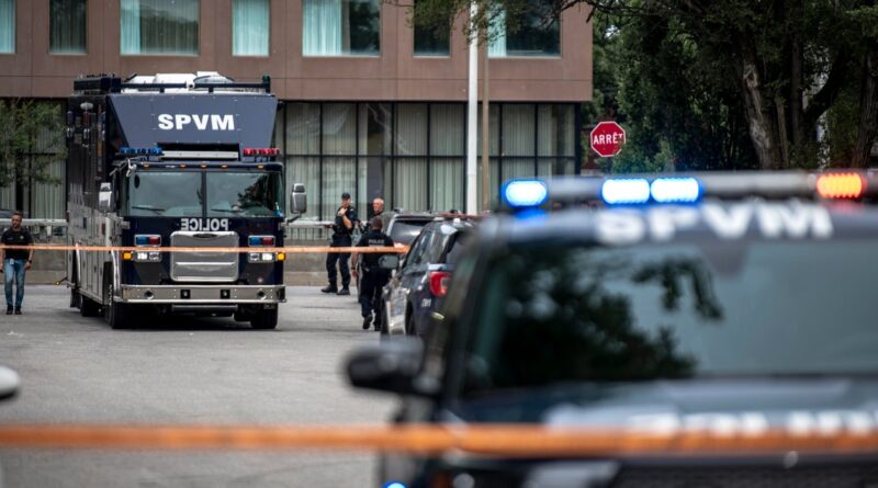 Armored SPVM police vehicle blocking a street with officers and orange tape at a scene gone under investigation in front of a building.