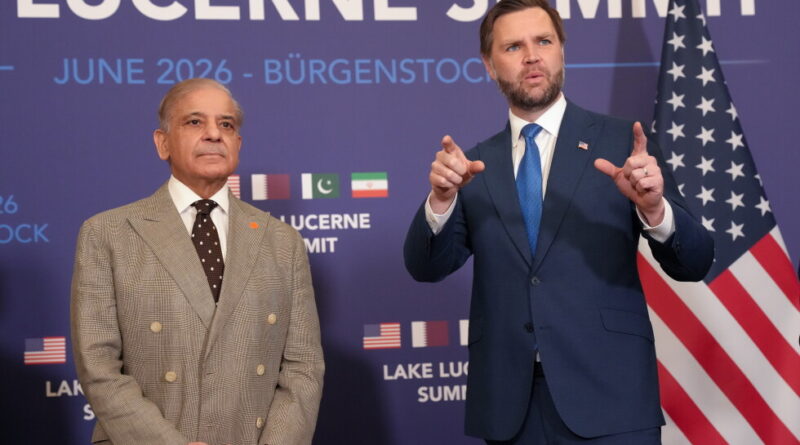 Two men in suits stand on stage at a Lucerne Summit backdrop; one gestures with hands while the other looks ahead, with an American flag nearby.
