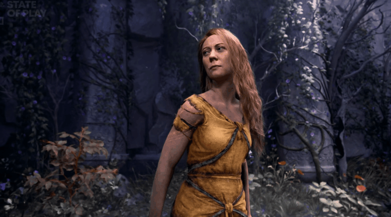 Woman with long blond hair in a worn yellow tunic stands in a shadowy forest scene.